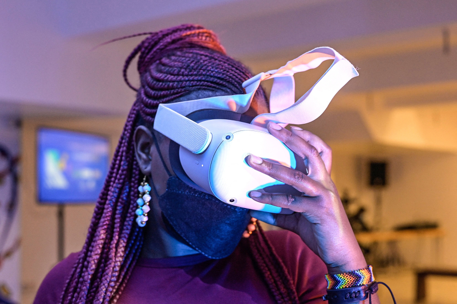 A woman tries out a virtual reality headset at a filmmaking class in Nairobi on Jan. 28, 2022.