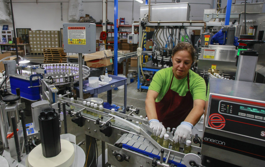 Leticia Maldonado works in the packing area at the factory for the Dr. Bronner's company on October 24, 2019 in Vista, California.