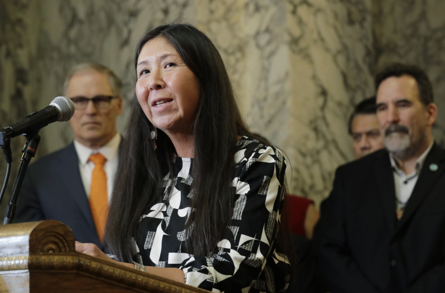 Washington state Rep. Debra Lekanoff, D-Bow, speaks during a bill signing ceremony for a measure that expands voting services on tribal reservations, Thursday, March 14, 2019, at the Capitol in Olympia, Wash. The bill requires county officials to establish at least one voting drop box on any Indian tribal reservation if requested by the tribe, and allows tribal members to register to vote using non-traditional addresses. (AP Photo/Ted S.
