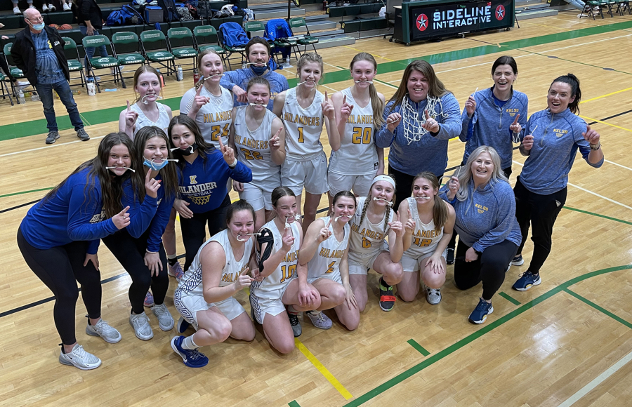 The Kelso girls basketball team pose for a team photo after winning the 3A bi-district tournament title, 66-46 over Auburn on Saturday, Feb. 19, 2022.