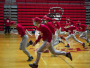 The Fort Vancouver baseball team runs through drills during their midnight practice on Feb.