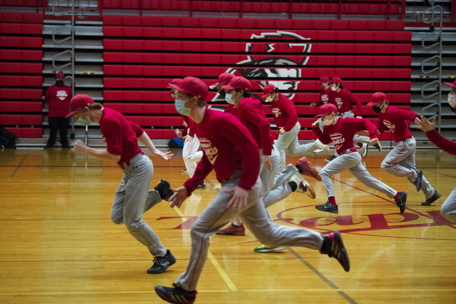The Fort Vancouver baseball team runs through drills during their midnight practice on Feb.