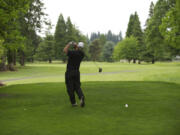 A golfer plays a round at Club Green Meadows golf course. The club is for sale, but the sellers wish for the golf course to remain.