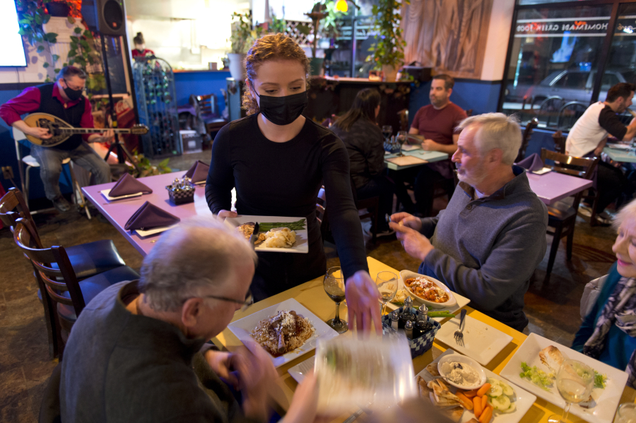 Ali Sharp serves main courses at George's Molon Lav?. For workers and restaurant owners, Valentine's Day is a happy occasion. "It's a great morale booster for staff," said Anthony Anton, chief executive at the Washington Hospitality Association.