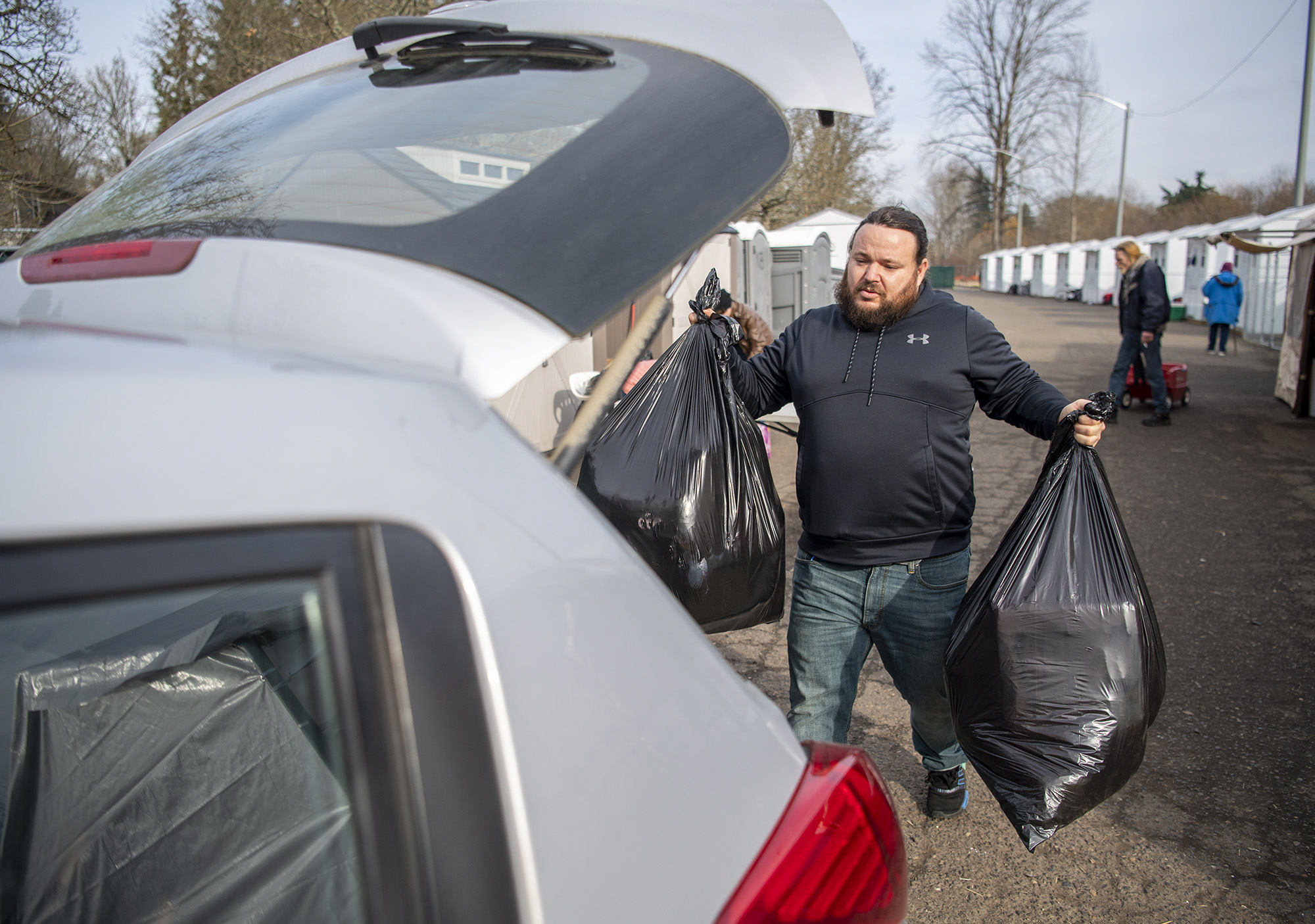 Stay Safe Community program manager Matthew Oakes loads donations into a vehicle Tuesday, Feb. 8, 2022, at the Stay Safe Community in east Vancouver. The site received a large donation of clothing and staff decided to send excess to Open House Ministries.
