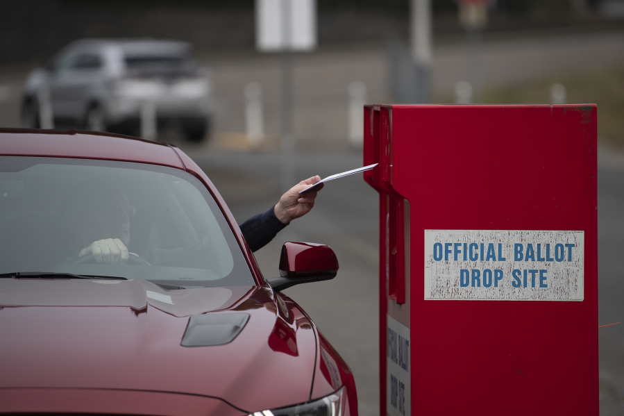 A voter swings by the Fisher's Landing ballot drop-off box on Monday for today's special election. The election includes funding measures for the city of Vancouver as well as several school bond or levy measures.