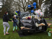 LEADSHOT Vancouver resident Cynthia Tilton, left, joins her daughter, McKynzie McFadden, 8, as they honor the memory of Officer Donald Sahota at a memorial outside the Vancouver Police Department headquarters Friday morning, Feb. 4, 2022. Tilton said Officer Sahota helped her through a difficult time in her life because he was kind and willing to listen. He was just a great guy, she said. Sahota, 52, was mistakenly shot at his home near Battle Ground by Clark County sheriffs Deputy Jonathan Feller during a manhunt for a robbery suspect Saturday night.