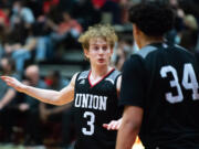 Union's Bryson Metz, shown here during Tuesday's game against Camas, poured in 18 second-half points to help lift the Titans to a 74-52 victory in Wednesday's tiebreaker game against Camas.(Joshua Hart/For The Columbian)