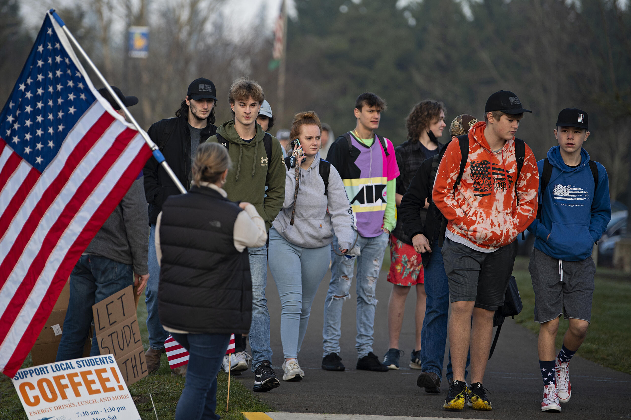 Students join a small group of protesters demonstrating against mandatory masks in schools outside Ridgefield High School on Wednesday morning, Feb. 9, 2022.