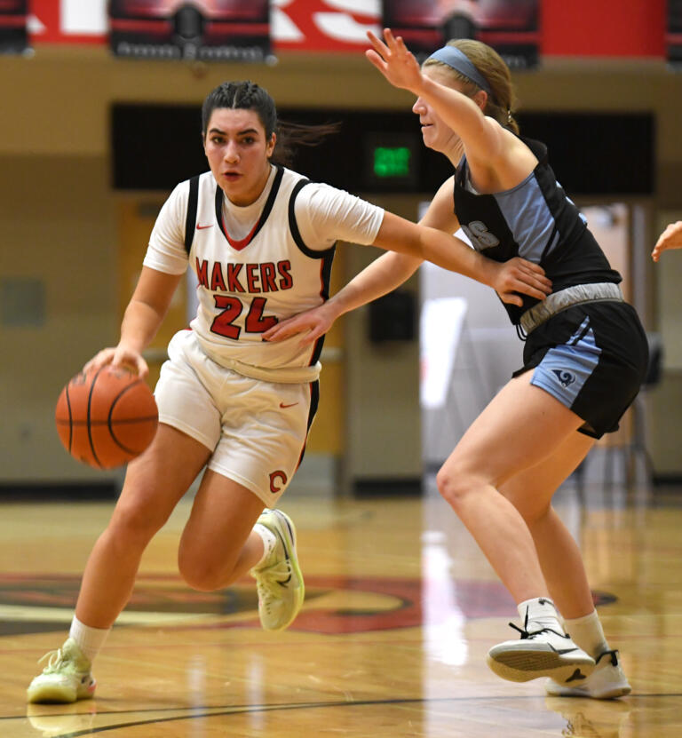 Camas sophomore Ava Smith moves the ball Friday, Feb. 11, 2022, during the Papermakers’ 65-34 win against Rogers-Puyallup at Camas High School.