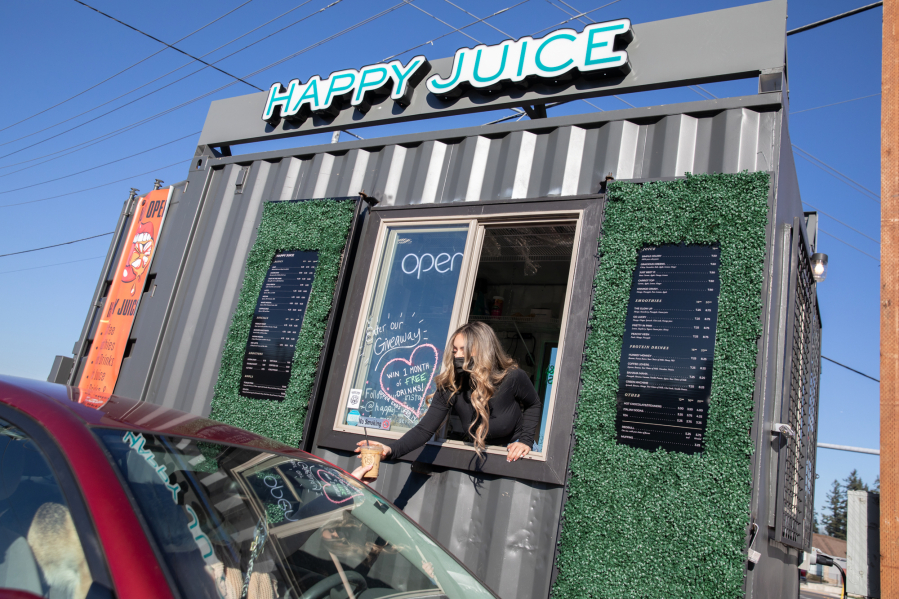 Happy Juice owner Ashley Lingle serves customers at her drive-thru.