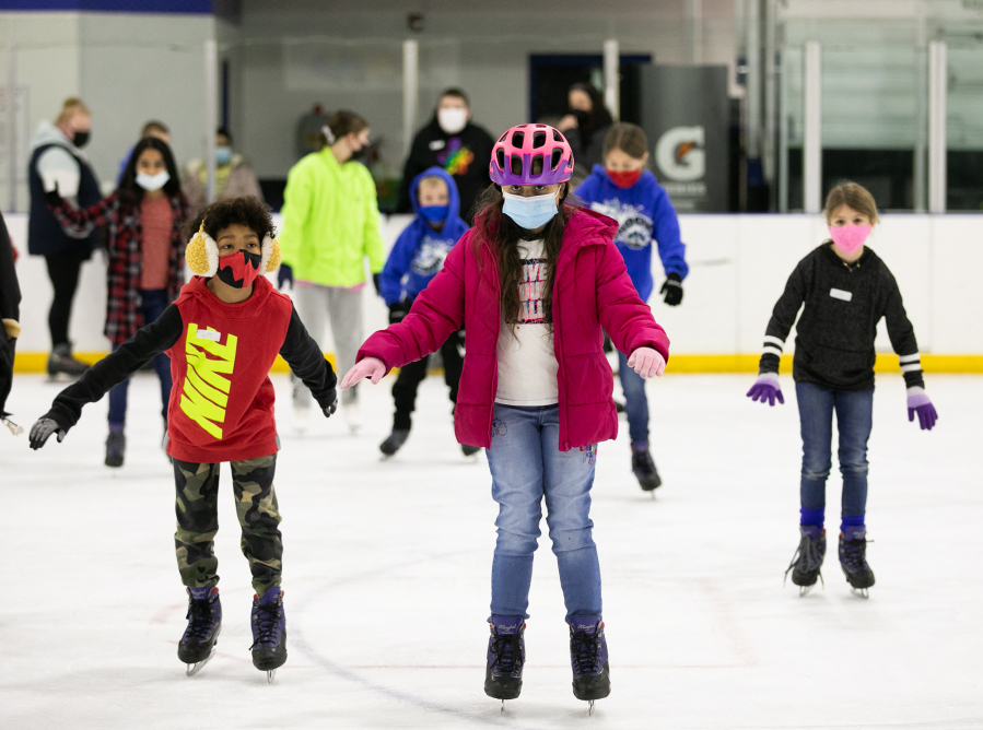 Layla Fluegel, 10, of Vancouver, works to keep her balance while making her way across the ice during a free lesson at Mountain View Ice Arena in Vancouver on Saturday.