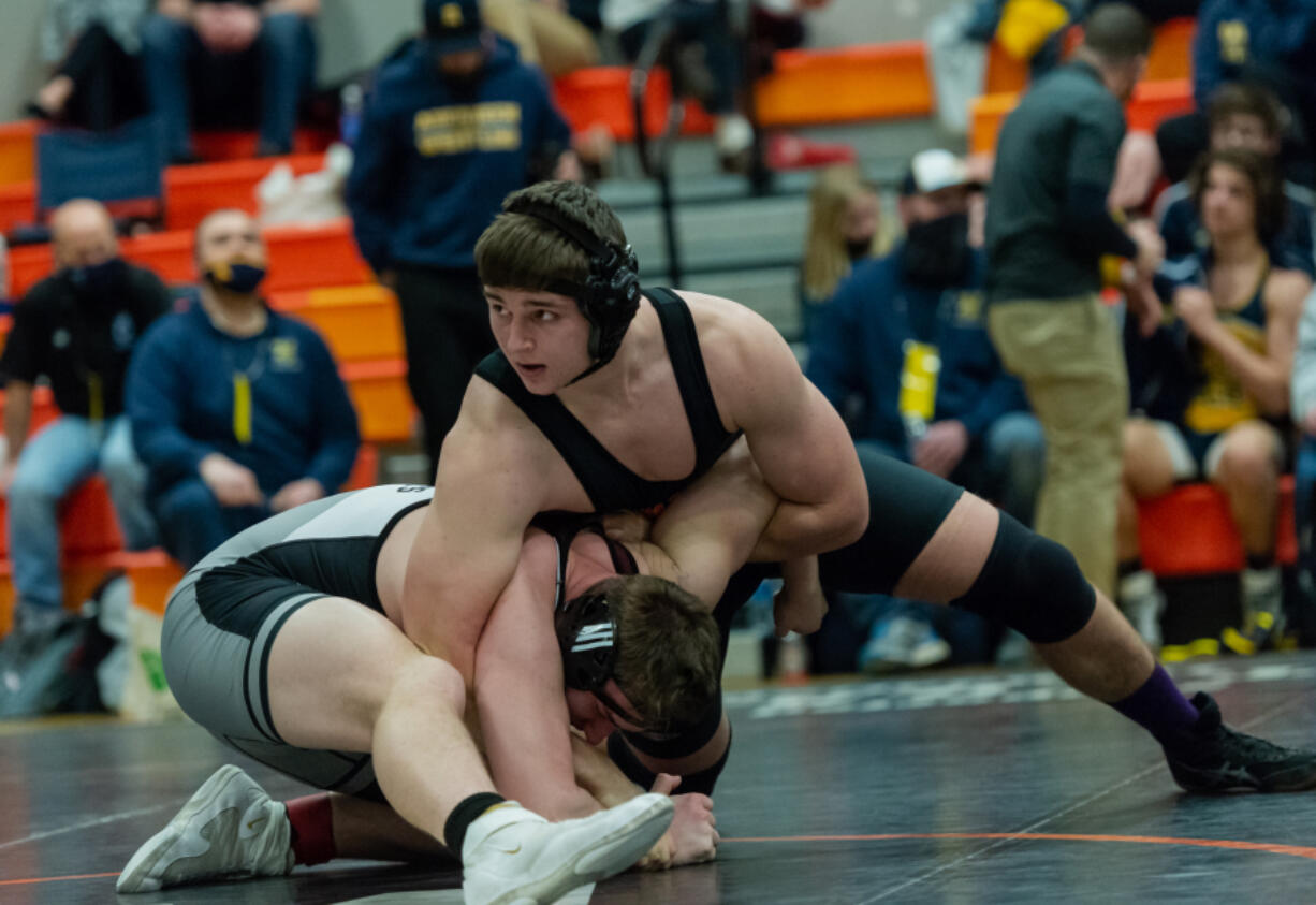 Washougal's Henry Jones holds down W.F. West's Andrew Penland as he awaits further instruction in the 220-pound championship match in the 2A Region 3 Wrestling Tournament on Saturday, Feb. 12, 2022, at Washougal High School.
