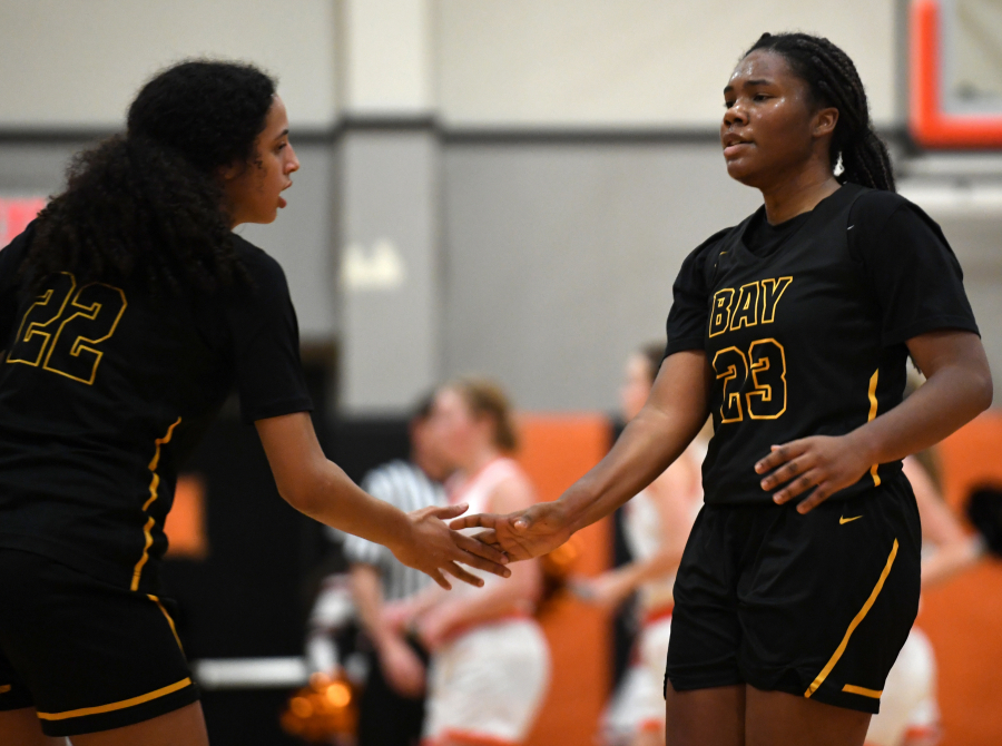 Hudson's Bay senior Aniyah Hampton, right, celebrates with a teammate Tuesday, Dec. 14, 2021, during the Eagles' 57-54 loss to Washougal at Washougal High School.