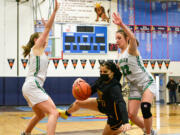 Hudson’s Bay sophomore Zoriah Jones, center, falls running between Tumwater sophomore Regan Brewer, right, and junior Kylie Waltermeyer on Friday, Feb. 18, 2022, during the Eagles’ 59-46 loss to Tumwater at Mark Morris High School in Longview.