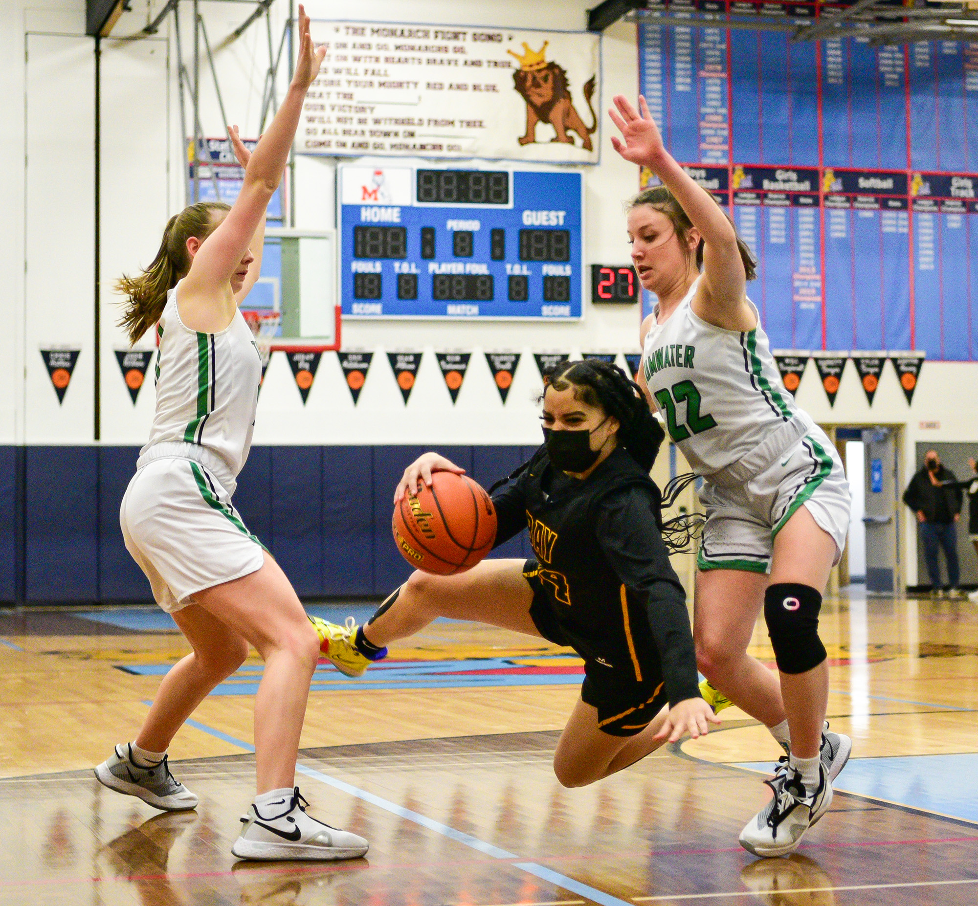 Hudson’s Bay sophomore Zoriah Jones, center, falls running between Tumwater sophomore Regan Brewer, right, and junior Kylie Waltermeyer on Friday, Feb. 18, 2022, during the Eagles’ 59-46 loss to Tumwater at Mark Morris High School in Longview.
