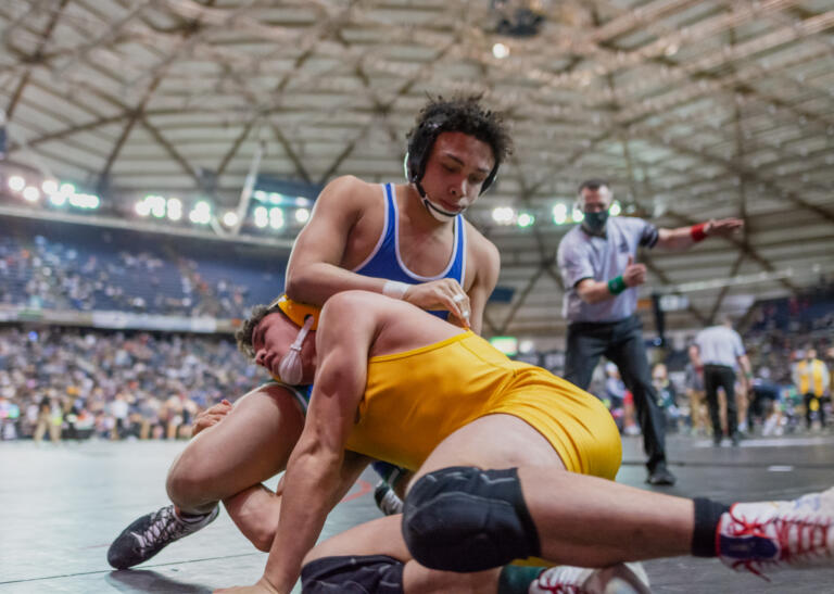 Mountain View's CJ Hamblin stuffs a takedown attempt by Capital's Ezekiel McEwen during a semifinal match at Mat Classic XXXIII on Saturday, Feb. 19, at the Tacoma Dome.