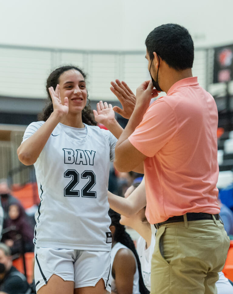 Hudson's Bay's Mahaila Harrison celebrates with assistant Jesus Garcia after checking out of the game late in a WIAA State Regional basketball game on Saturday, Feb. 26, 2022, at Battle Ground High School.