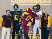 Dan and Tanya Snyder, co-owners and co-CEOs of the Washington Commanders, unveil their NFL football team's new identity, Wednesday, Feb. 2, 2022, in Landover, Md. The new name comes 18 months after the once-storied franchise dropped its old moniker following decades of criticism that it was offensive to Native Americans.