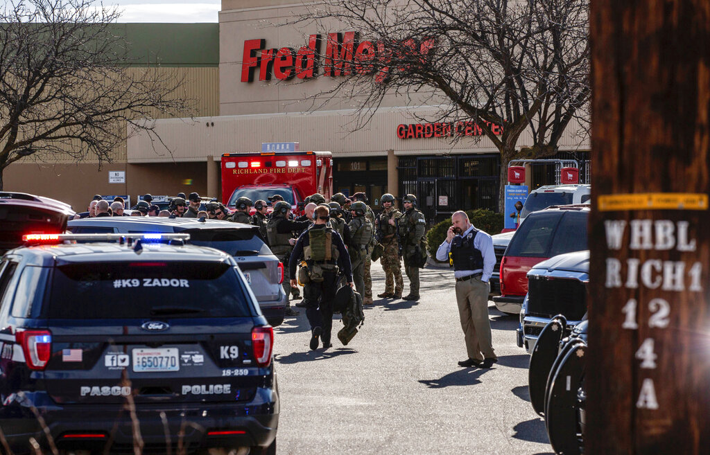 Authorities stage outside a Fred Meyer grocery store after a fatal shooting at the business on Wellsian Way in Richland, Wash., Monday, Feb. 7, 2022.