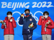 From left, silver medalist Yuma Kagiyama of Japan, gold medalist Nathan Chen of the United States and bronze medalist Shoma Uno of Japan celebrate during the medal ceremony for the men's free skate figure skating at the 2022 Winter Olympics, Thursday, Feb. 10, 2022, in Beijing. (AP Photo/Jae C.