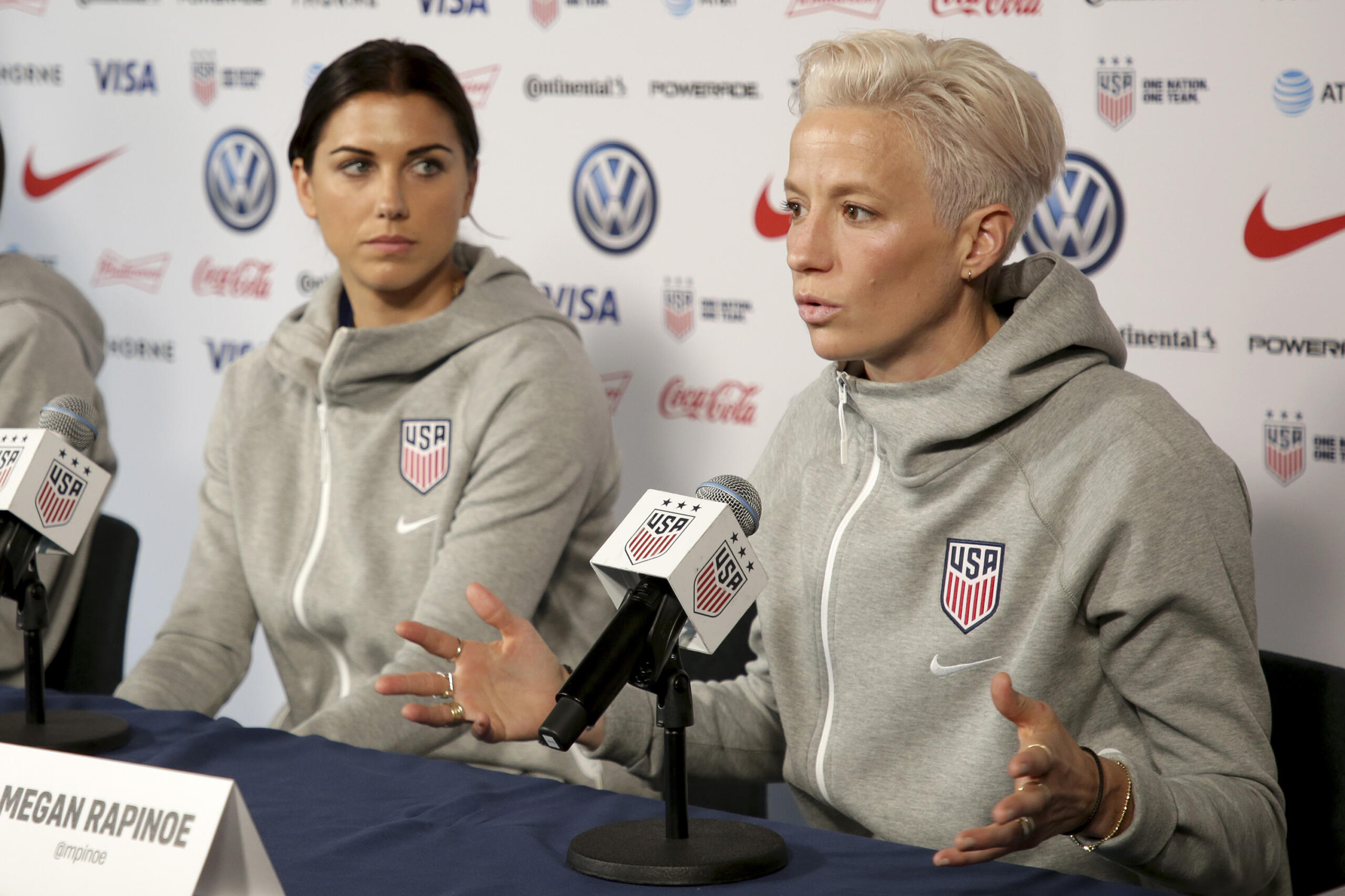 United States women's national soccer team members Alex Morgan, left, and Megan Rapinoe pictured at a 2019 press conference. U.S. women soccer players reached a landmark agreement with the sport’s American governing body to end a six-year legal battle over equal pay, a deal in which they are promised $24 million plus bonuses that match those of the men. The U.S. Soccer Federation and the women announced a deal Tuesday, Feb. 22, 2022, that will have players split $22 million, about one-third of what they had sought in damages.