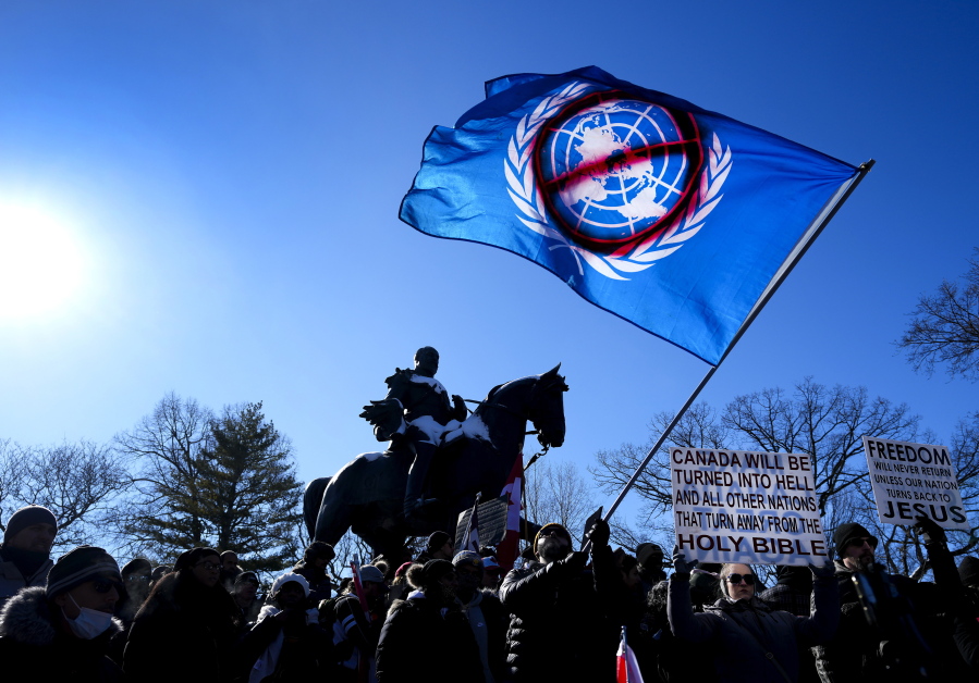 People protest in support of a trucker convoy protesting COVID-19 restrictions, at Queen's Park in Toronto, Saturday, Feb. 5, 2022.