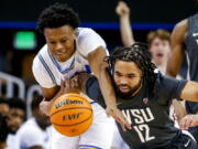 UCLA guard Jaylen Clark, left, and Washington State guard Michael Flowers compete for the ball during the first half of an NCAA college basketball game Thursday, Feb. 17, 2022, in Los Angeles. (AP Photo/Ringo H.W.