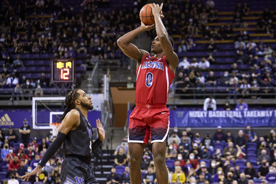 Arizona's Bennedict Mathurin shoots over Washington's PJ Fuller during the first half of an NCAA college basketball game Saturday, Feb. 12, 2022, in Seattle.
