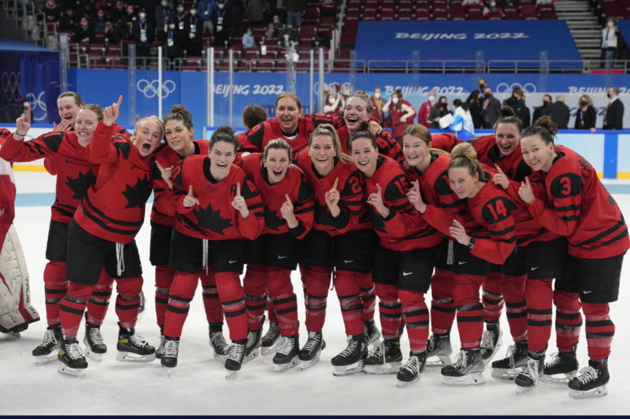 Canada poses after defeating the United States in the women's gold medal hockey game at the 2022 Winter Olympics, Thursday, Feb. 17, 2022, in Beijing.