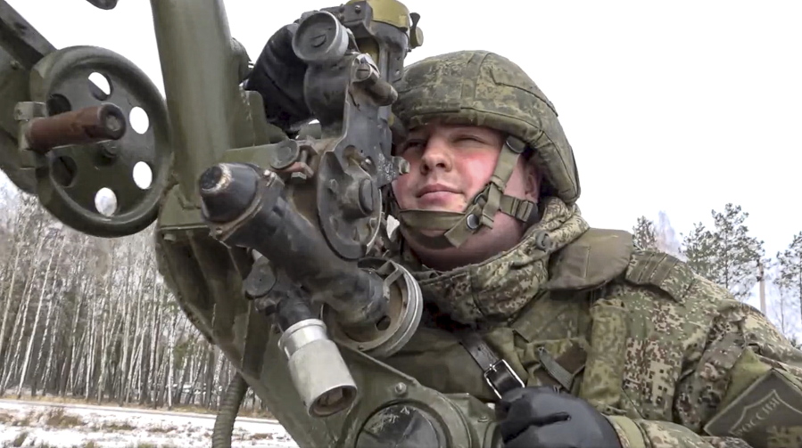 In this photo taken from video and released by the Russian Defense Ministry Press Service on Friday, Feb. 4, 2022, a soldier takes part in the Belarusian and Russian joint military drills at Brestsky firing range, Belarus. Russian and Belarus troops held joint combat training at firing ranges in Belarus. The drills involved motorized rifle, artillery and anti-tank missile units, as well tanks and armored personnel carriers crews.