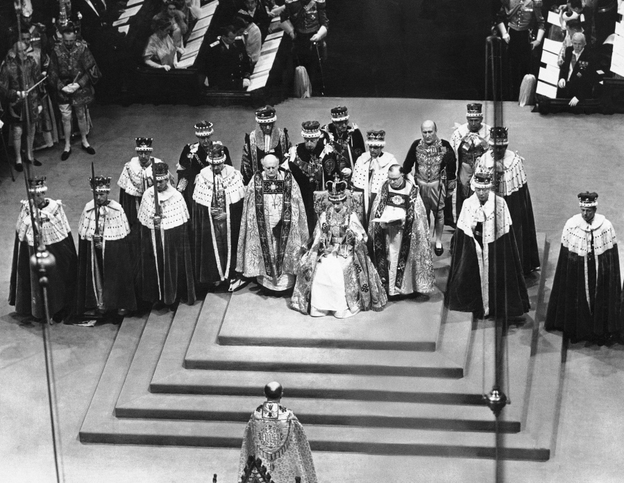FILE - Surrounded by peers and churchmen, Queen Elizabeth II sits on throne in Westminister Abbey, London, June 2, 1953 after her coronation. Britain is marking Queen Elizabeth II's Platinum Jubilee on Sunday, Feb. 6, 2022, 70 years after she ascended to the throne.