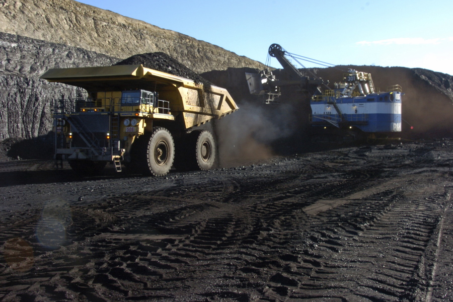In this Nov. 15, 2016 photo, a haul truck with a 250-ton capacity carries coal after being loaded from a nearby mechanized shovel at the Spring Creek strip mine near Decker, Mont. The mine is in the Powder River Basin of Montana and Wyoming, the largest source of coal in the U.S. Environmentalists are pushing to end mining because emissions from burning coal help drive climate change.