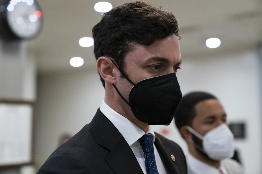 FILE - Sen. Jon Ossoff, D-Ga., walks on Capitol Hill, on Oct. 7, 2021, in Washington. Pressure is building for Congress to pass legislation that would curtail lawmakers' ability to speculate on the stock market. Public anger over congressional stock trading has mounted since the first tremors of the pandemic.