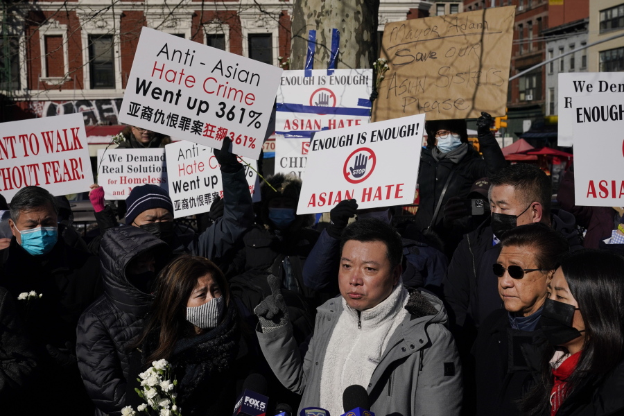 People hold signs and pictures of Christina Yuna Lee during a rally in the Chinatown section of New York, Monday, Feb. 14, 2022. Lee was stabbed to death inside her lower Manhattan apartment by a man who followed her from the street into her building, authorities said.