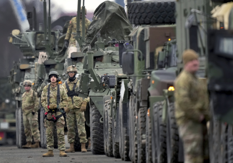 Soldiers of the 2nd Cavalry Regiment line up vehicles at the military airfield in Vilseck, Germany, Wednesday, Feb. 9, 2022 as they prepare for the regiment's movement to Romania loading of Stryker combat vehicles for their deployment to support NATO allies and demonstrate U.S. commitment to NATO Article V. The soldiers will deploy to Romania in the coming days from their post in Vilseck and will augment the more than 900 U.S. service members already in Romania. This Stryker Squadron represents a combined arms unit of lightly armored, medium-weight wheeled combat vehicles.