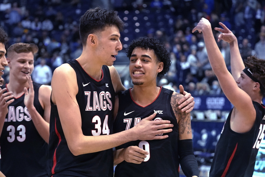 Gonzaga center Chet Holmgren (34) andguard Julian Strawther (0) walk off the court following the team's win in an NCAA college basketball game against BYU on Saturday, Feb. 5, 2022, in Provo, Utah.