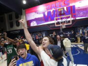 Saint Mary's guard Alex Ducas, middle, celebrates with fans after Saint Mary's defeated Gonzaga in an NCAA college basketball game in Moraga, Calif., Saturday, Feb. 26, 2022.