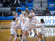 The Hockinson girls basketball players celebrate after their 58-53 win over Washougal on Wednesday, Feb.
