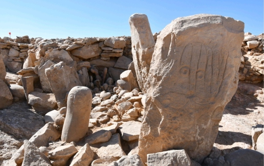 This photo provided by Jordan Tourism Ministry shows two carved standing stones at a remote Neolithic site in Jordan's eastern desert.  A team of Jordanian and French archaeologists said Tuesday, Feb. 22, 2022,  that it had found a roughly 9,000-year-old shrine.  The ritual complex was found in a Neolithic campsite near large structures known as "desert kites," or mass traps that are believed to have been used to corral wild gazelles for slaughter.