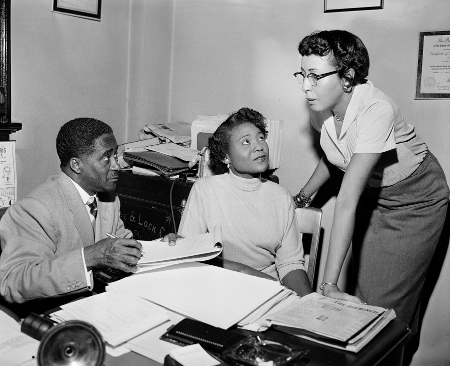 FILE - This file photo shows Autherine Lucy Foster, center, the first Black person to attend University of Alabama, discussing her return to campus following mob demonstrations in Birmingham, Ala., on Feb. 7, 1956. She held a press conference accompanied by Ruby Hurley, right, Southeast regional secretary of the NAACP, and attorney Arthur Shores, left. The school in 2022 decided to add Foster's name to a building already named for a KKK leader and former governor.