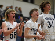 King’s Way sophomore Cade Erwin, left, senior Aidan Peterson, middle, and sophomore Brayden Schiefer celebrate after a basket Tuesday, Feb. 1, 2022, during the Knights’ 32-23 win against Seton Catholic at King’s Way Christian High School.