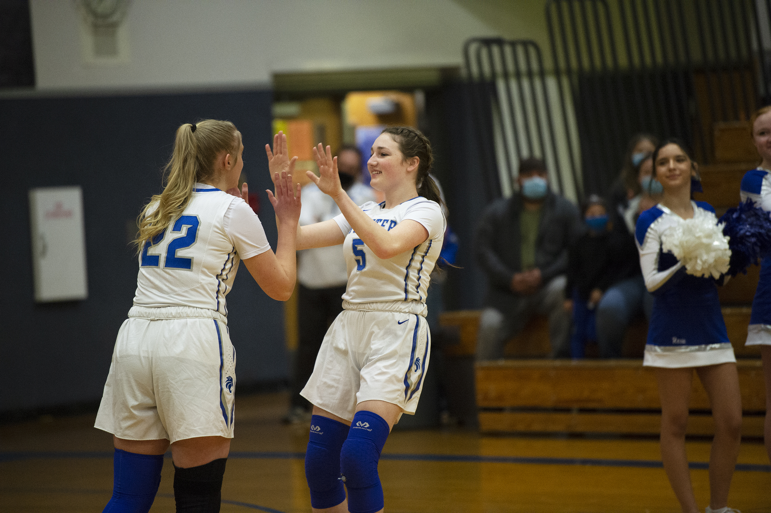 La Center’s Gianna D’Emilio (5) is greeted by Alyse Webberley (22) during pre-game introductions before the 1A district semifinal against Tenino at La Center High School on Tuesday.