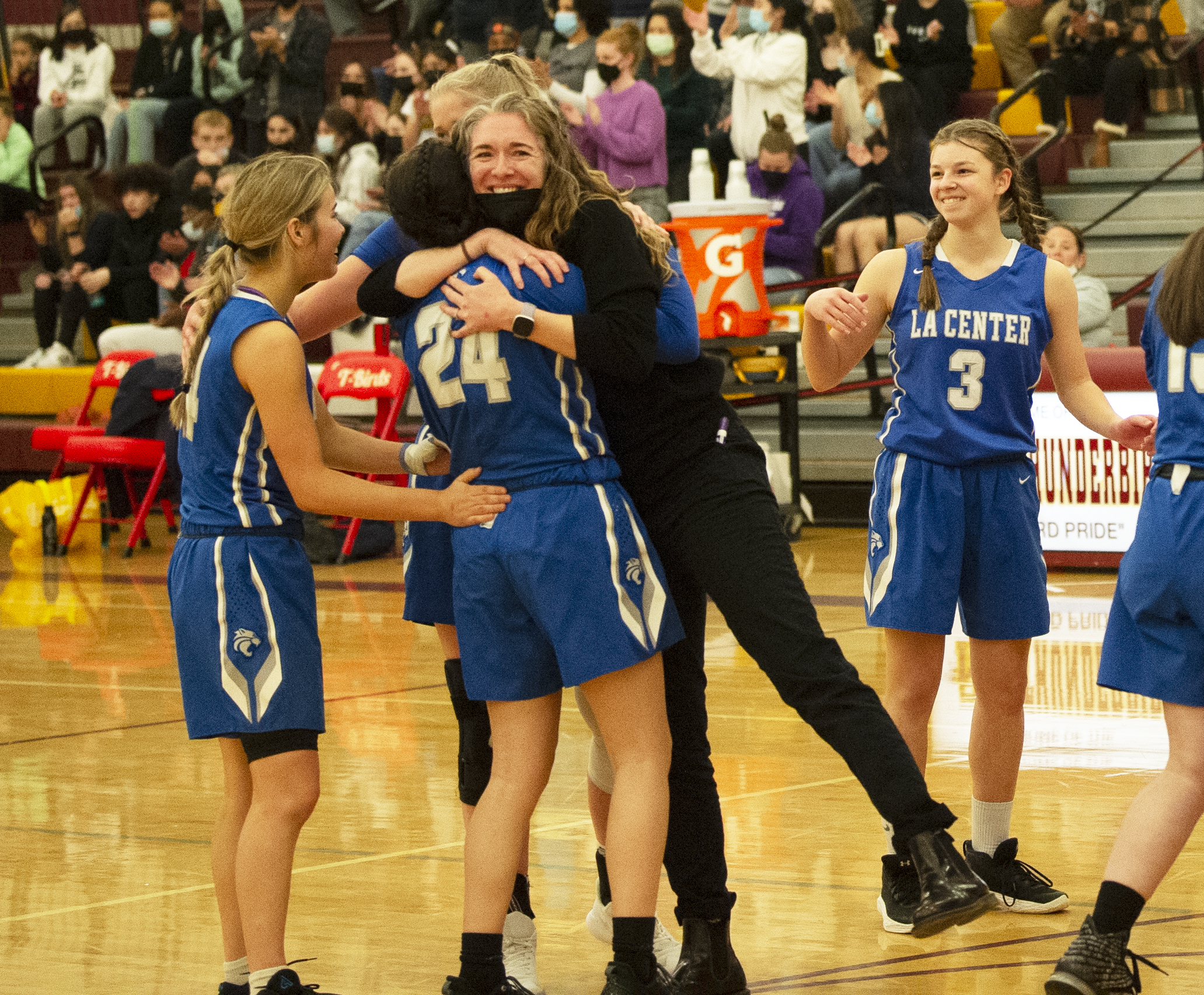 La Center coach Brittney Stryker hugs Kylee Stephens (24) after the Wildcats beat Annie Wright 52-48 in the 1A girls basketball regional at Mt. Tahoma High School in Tacoma.