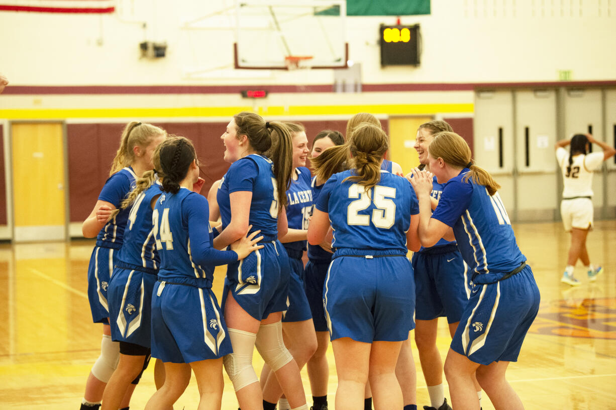 The La Center's basketball team celebrate after their 52-48 win over Annie Wright in the 1A girls basketball regional at Mt. Tahoma High School in Tacoma.
