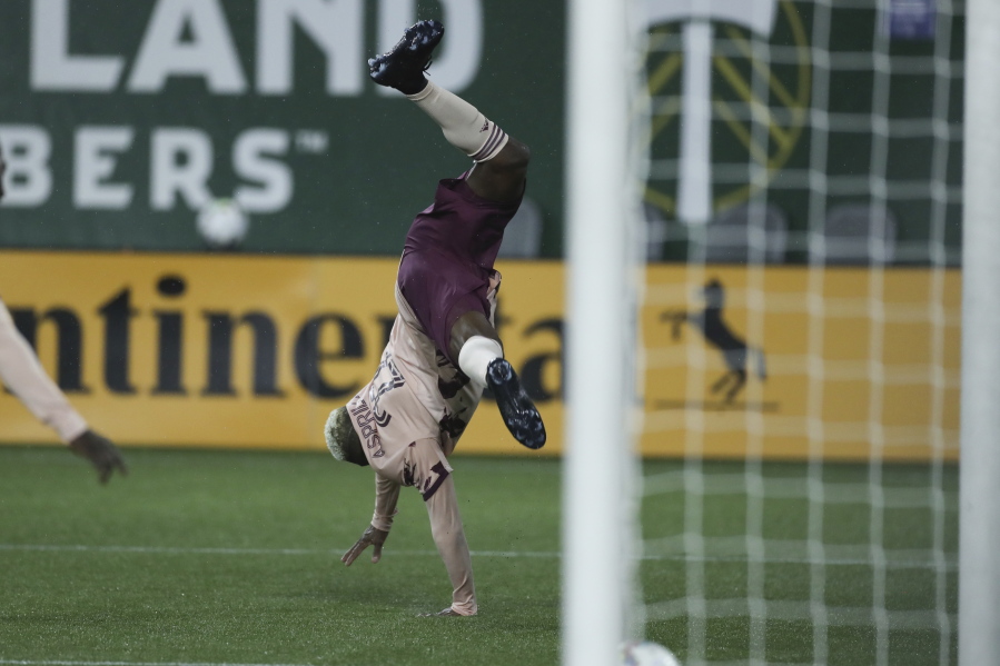 Portland Timbers midfielder Dairon Asprilla (27) does a cartwheel while celebrating after scoring a goal against the New England Revolution during the second half of an MLS soccer match, Saturday, Feb. 26, 2022, in Portland, Ore.