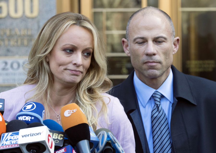 FILE- Adult film actress Stormy Daniels, accompanied by her attorney, Michael Avenatti, right, talks to the media as she leaves federal court, on April 16, 2018 in New York.The jury deliberating the fate of Michael Avenatti on charges that he ripped off his star client, Stormy Daniels, has told a judge that it is deadlocked on the first of two counts he faces.