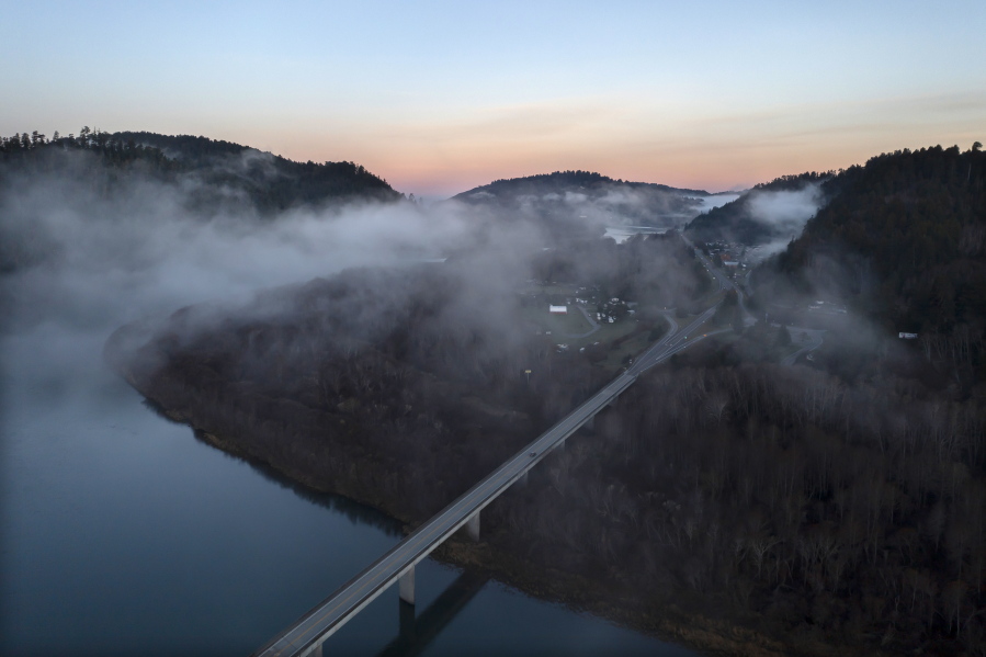 In this aerial image taken from a drone, the city of Klamath, Calif., home of the tribal headquarters for the Yurok Tribe, dots the side of U.S. Highway 101 at sunrise on Jan. 21, 2022. The Native American tribe has issued an emergency declaration on human trafficking and missing women. There have been five instances in the past 18 months where Indigenous women have gone missing or been murdered between San Francisco and the Oregon border.