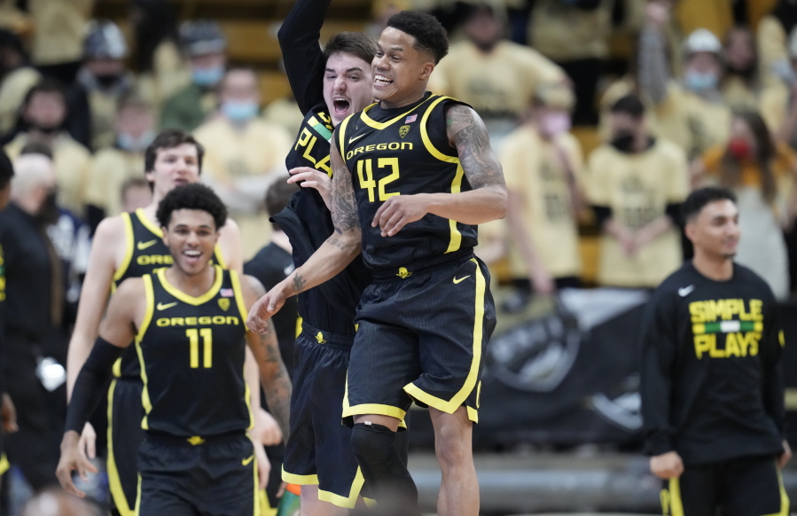 Oregon guard Jacob Young, front, celebrates with center Nate Bittle as time runs out in the second half of an NCAA college basketball game against Colorado, Thursday, Feb. 3, 2022, in Boulder, Colo.