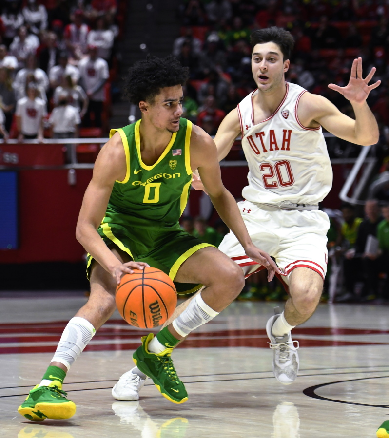 Utah guard Lazar Stefanovic (20) defends against Oregon guard Will Richardson (0) during the first half of an NCAA college basketball game Saturday, Feb. 5, 2022, in Salt Lake City.